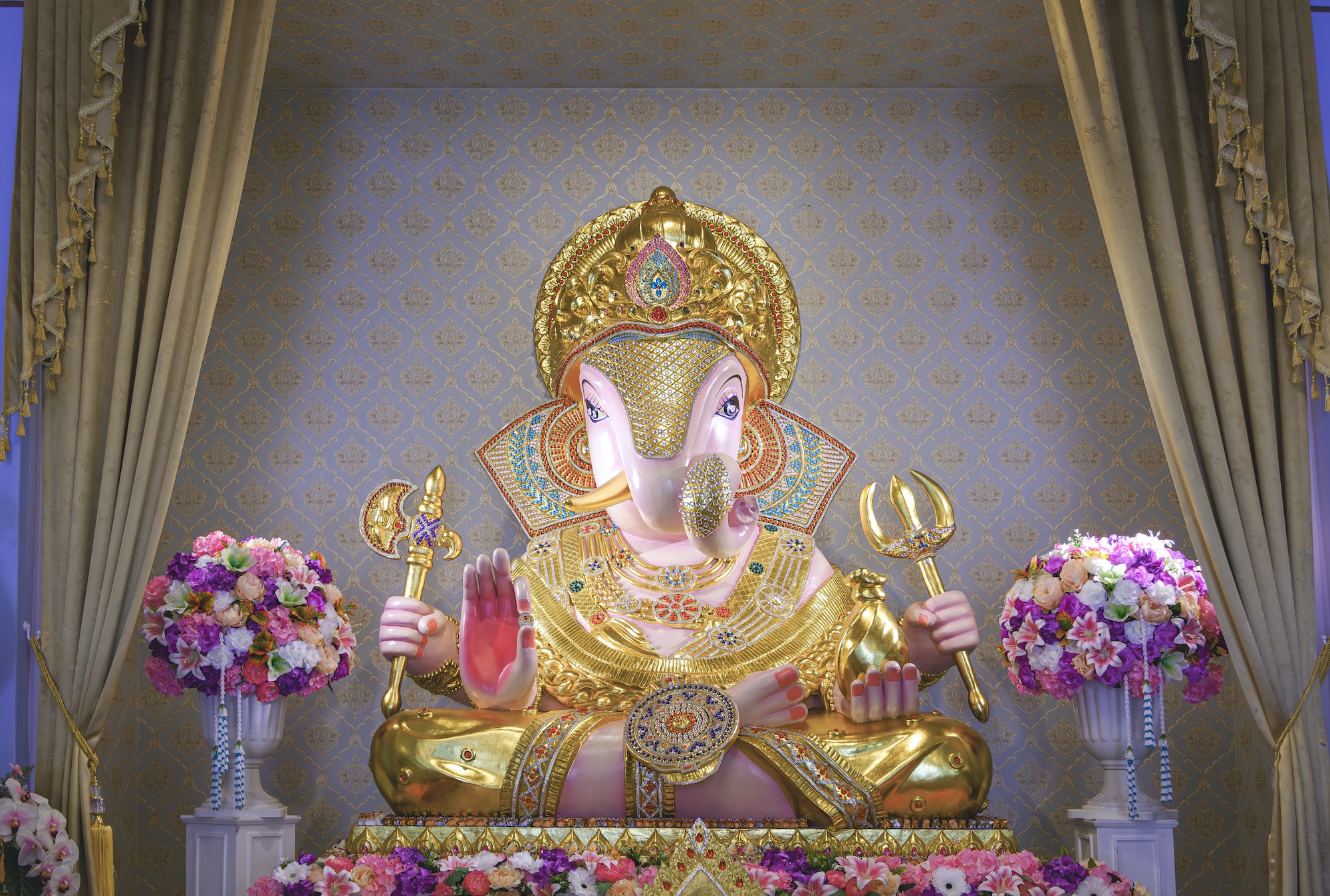 Beautiful Lord Ganesha Dagadusheth statue enshrined in a Hindu temple